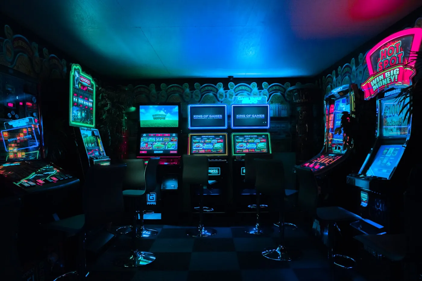Two pairs of hands gripping controllers, a game glowing on the TV between them